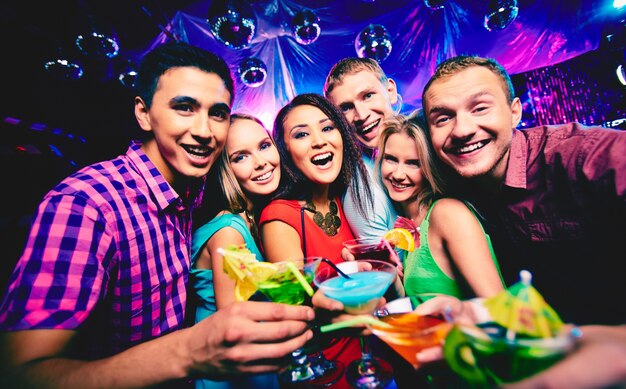 Gente joven brindando en la discoteca