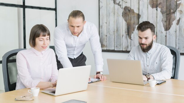 Gente de negocios trabajando con portátil en oficina