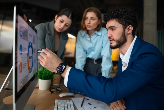 Gente en la oficina analizando y revisando gráficos financieros