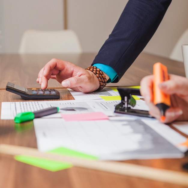 La gente de pie apoyándose en el trabajo de escritorio