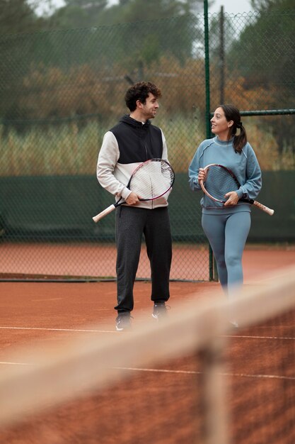 Gente preparándose para el juego de tenis en invierno