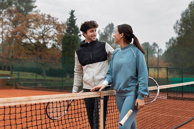 Gente preparándose para el juego de tenis en invierno