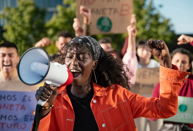 Gente de primer plano protestando con megáfono