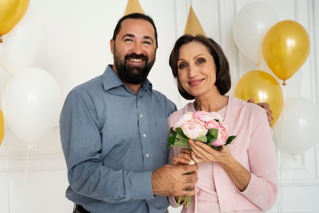 Foto gratuita gente sonriente con flores tiro medio