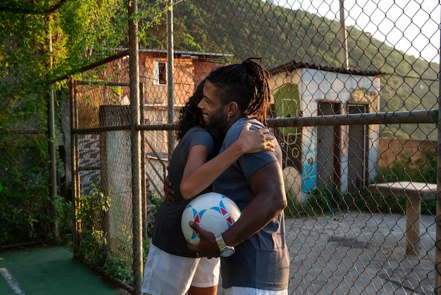 Gente de tiro medio con balón de fútbol.