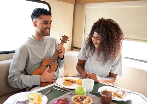 Gente de tiro medio con comida y guitarra.