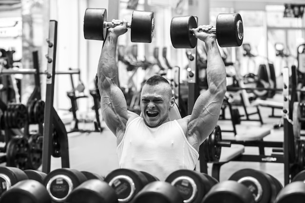 Gimnasio. Hombre guapo durante el entrenamiento