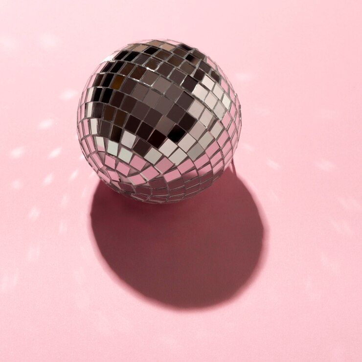 Foto gratuito globo de discoteca de alto ángulo sobre fondo rosa