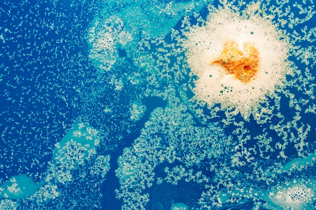 Foto gratuita gota amarilla en agua azul