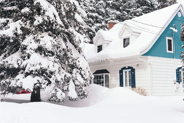 Gran casa cubierta de nieve blanca durante el invierno