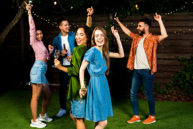 Grupo de amigos bailando juntos al aire libre