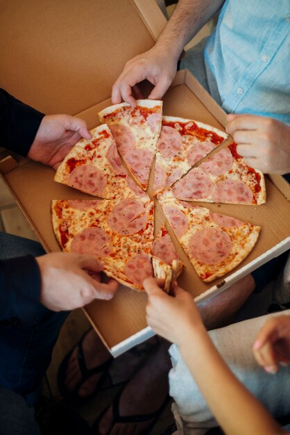 Grupo de amigos comiendo pizza