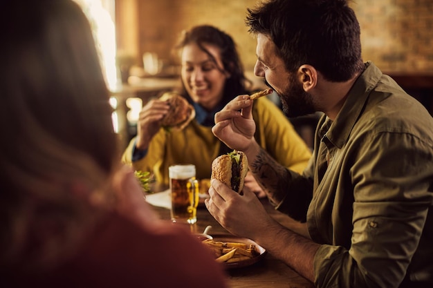 Grupo de amigos disfrutando mientras almorzamos en un pub