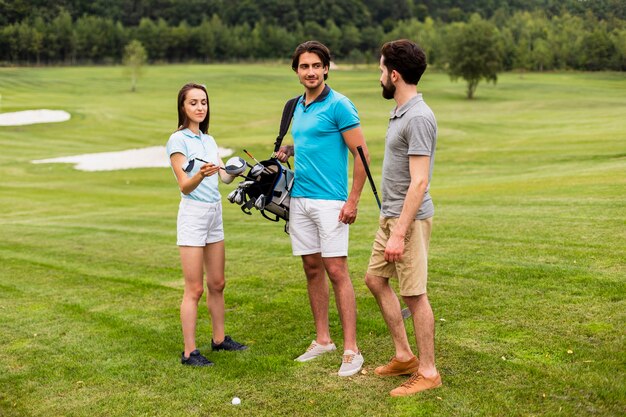 Grupo de amigos divirtiéndose en el campo de golf