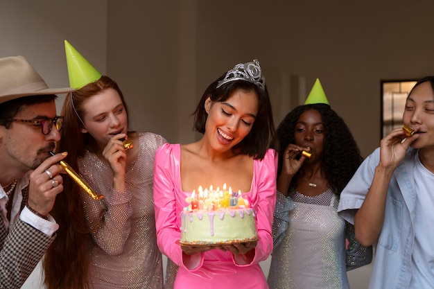 Grupo de amigos con pastel en una fiesta sorpresa de cumpleaños