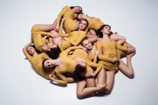 Foto gratuita grupo de bailarines de ballet moderno tirado en el piso