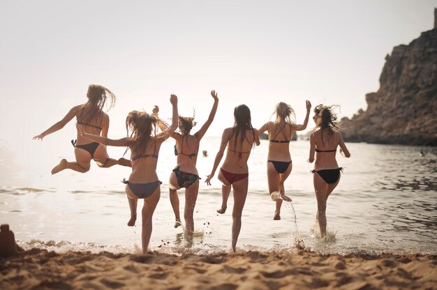 grupo de chicas corren en la playa