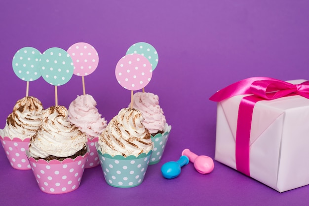 Grupo cupcakes junto a regalo