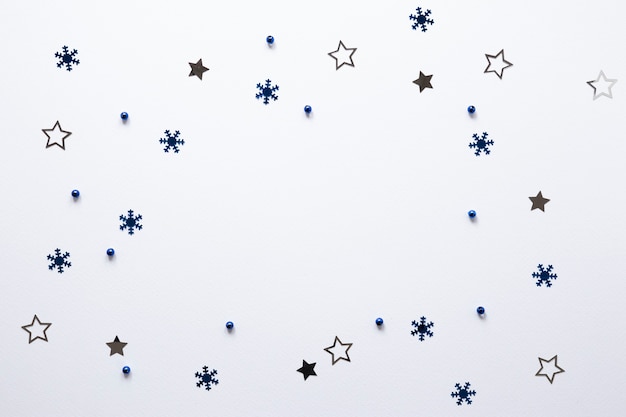 Grupo de estrellas y copos de nieve sobre fondo blanco.
