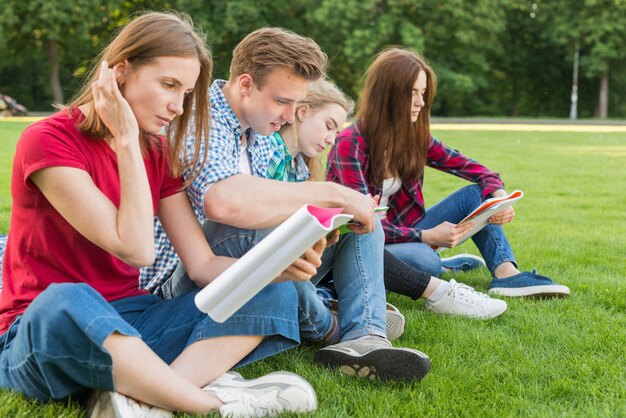 Grupo de estudiantes jóvenes estudiando en parque