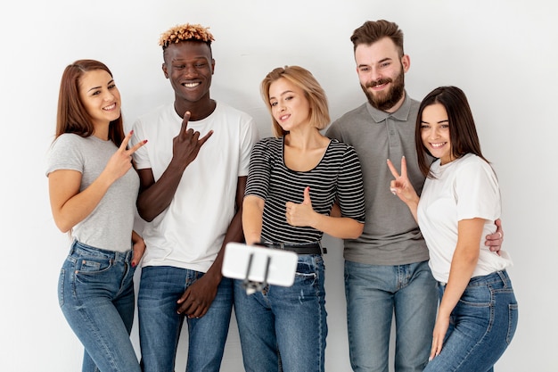 Grupo de jóvenes amigos tomando selfies