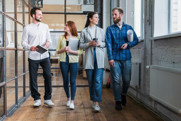 Grupo de jóvenes colegas de negocios caminando juntos