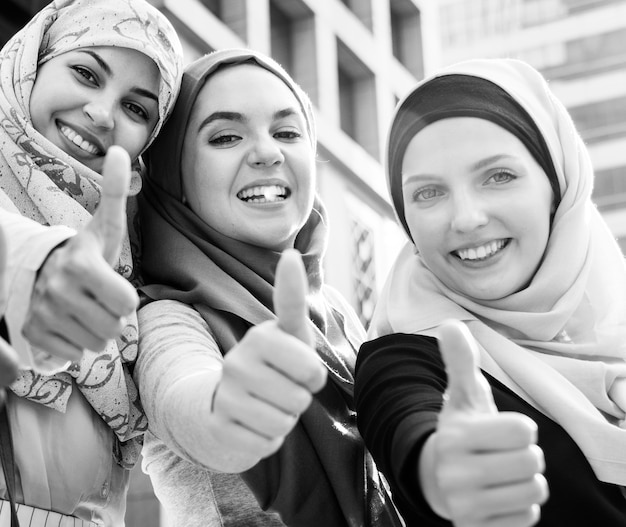 Foto gratuita grupo de mujeres islámicas gesticulando golpes arriba