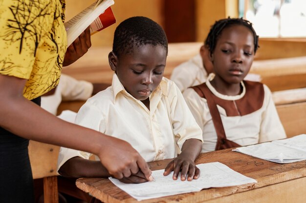 Grupo de niños africanos prestando atención a la clase.