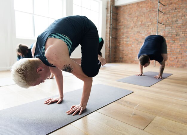 Grupo de personas diversas se unen a una clase de yoga.