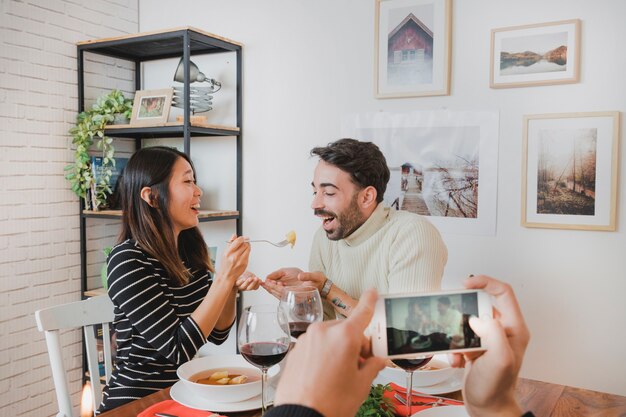 Haciendo foto de pareja feliz en cena de navidad