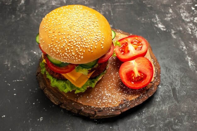 Hamburguesa de carne de vista frontal con verduras en sándwich de comida rápida de pan de superficie oscura