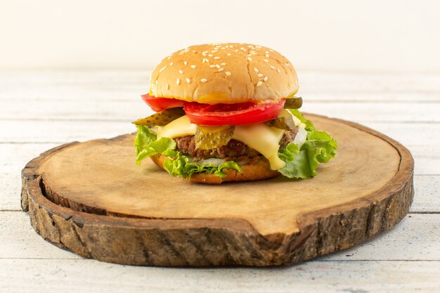 Una hamburguesa de pollo de vista frontal con queso y ensalada verde en el escritorio de madera y comida de comida rápida sándwich