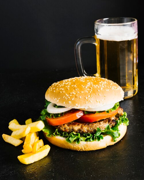 Hamburguesa de primer plano de alto ángulo con papas fritas y cerveza