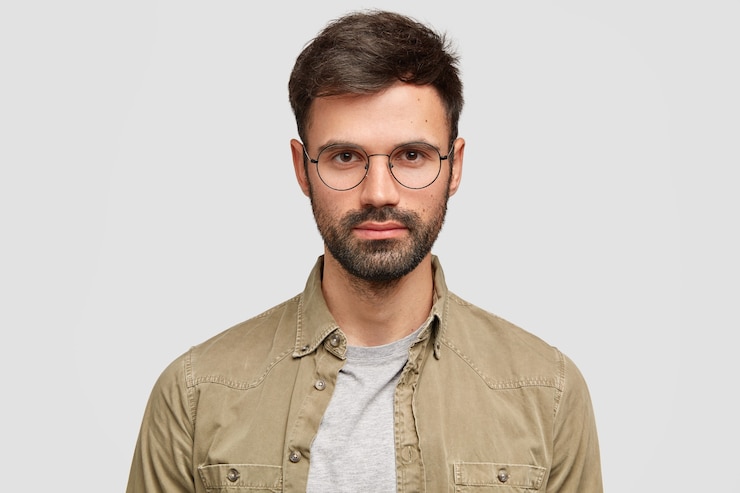 Photo Gratis handsome unshaven european man has serious self confident expression, wears glasses