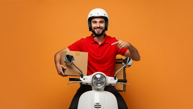 Happy delivery man with a package on a scooter