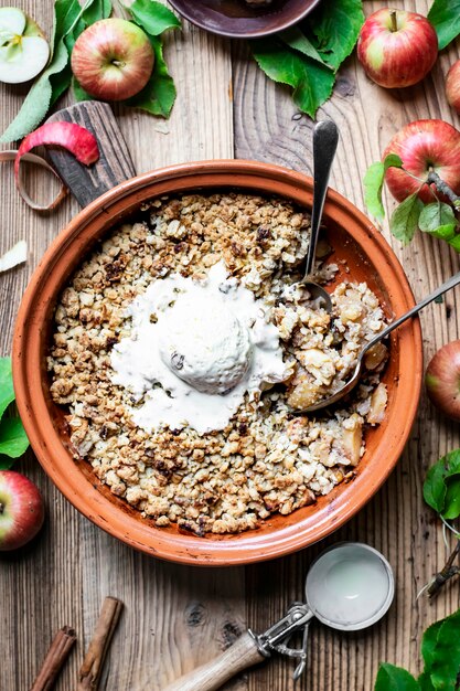 Helado de vainilla crumble de manzana casera sobre mesa de madera