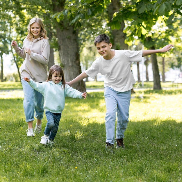 Hermanos y mamá corriendo juntos