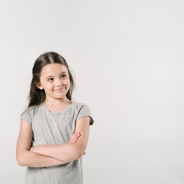 Hermosa chica de pie y sonriendo en estudio