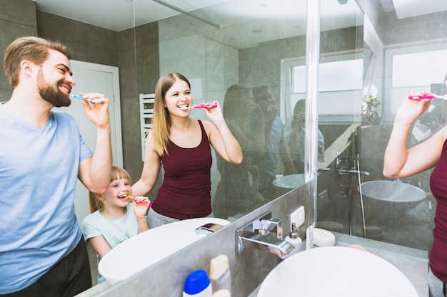 Hermosa familia cepillarse los dientes