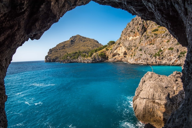 Hermosa foto de los acantilados cerca del océano a través del arco de piedra natural