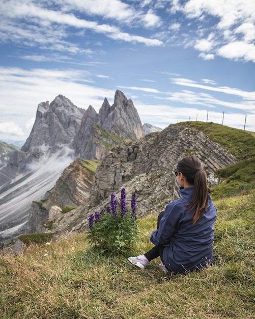 Hermosa foto de una mujer mirando las montañas en el Parque Natural Puez-Geisler, Miscì, Italia