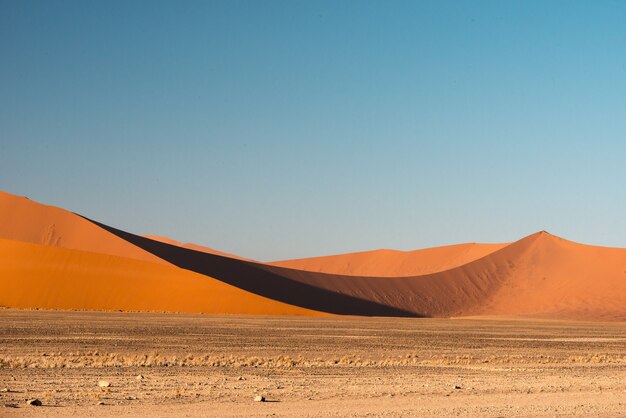 Hermosa imagen de las dunas del Parque Nacional Namib contra montañas de arena marrón