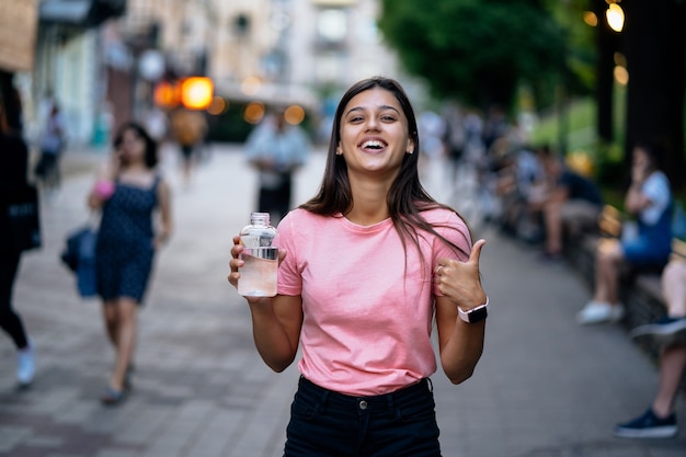 Hermosa joven con una botella de agua