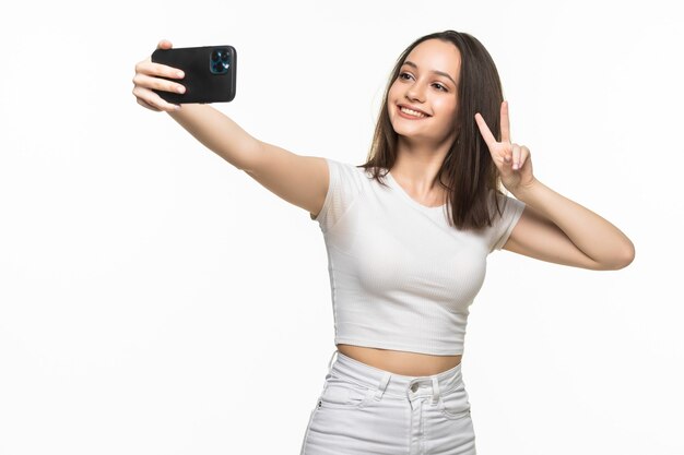 Hermosa joven está haciendo foto selfie con smartphone