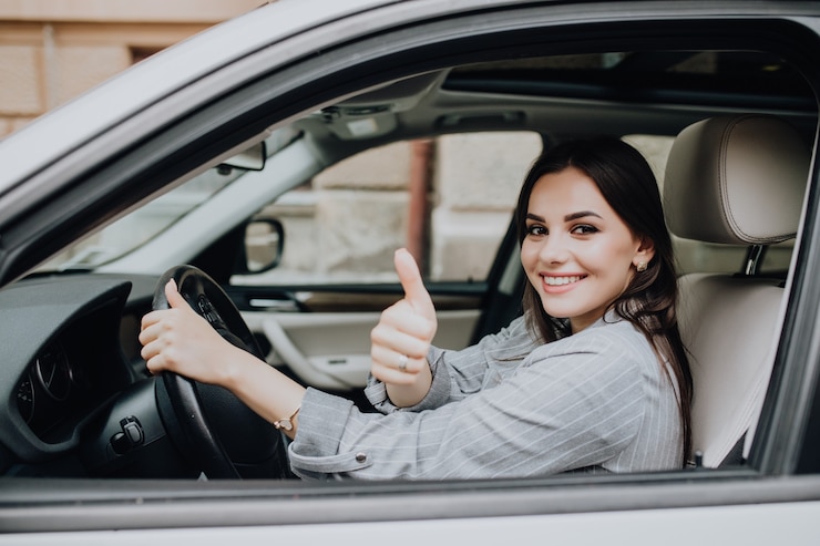 Foto gratuito hermosa joven latina conduciendo su auto nuevo y mostrando su pulgar hacia arriba