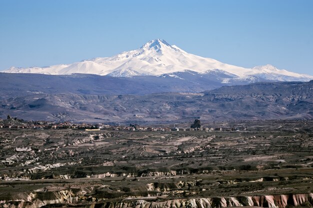 Hermosa montaña cubierta de nieve en el fondo bajo un cielo azul