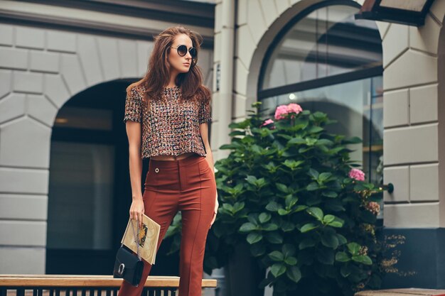 Hermosa morena de moda con ropa de moda y gafas de sol.