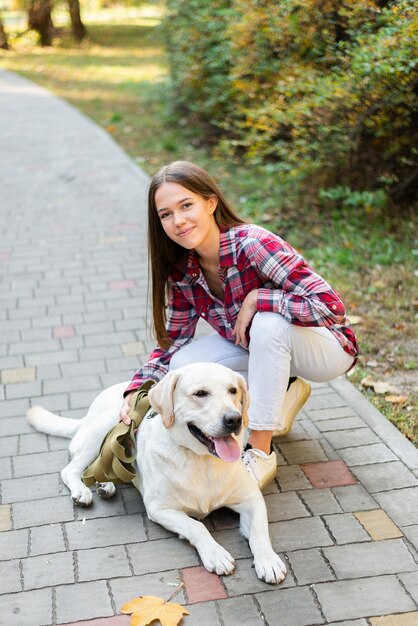 Hermosa mujer acariciando a su perro