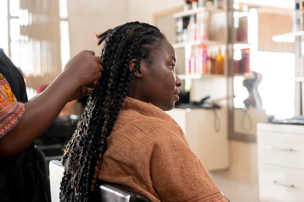 Hermosa mujer arreglando su cabello en el salón de belleza