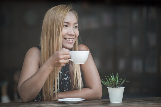 Hermosa mujer en un café tomando café